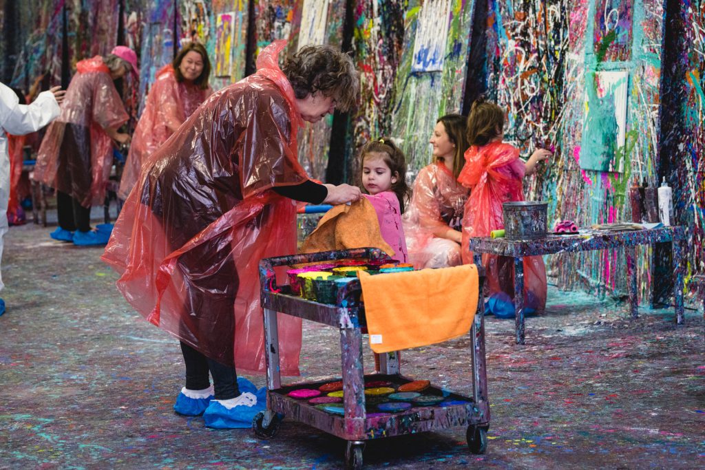 a group of people in a splatter painting session